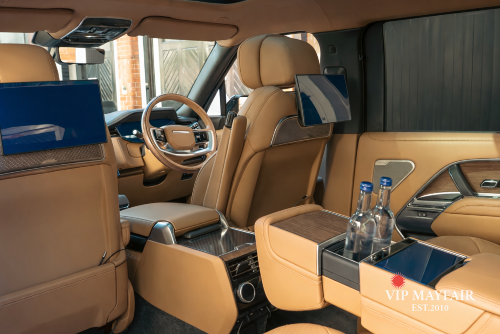 A Range Rover chauffeur-driven vehicle prepared to VIP Mayfair standards, equipped with complimentary water and chargers, ready for arrival at London Heliport, Battersea.